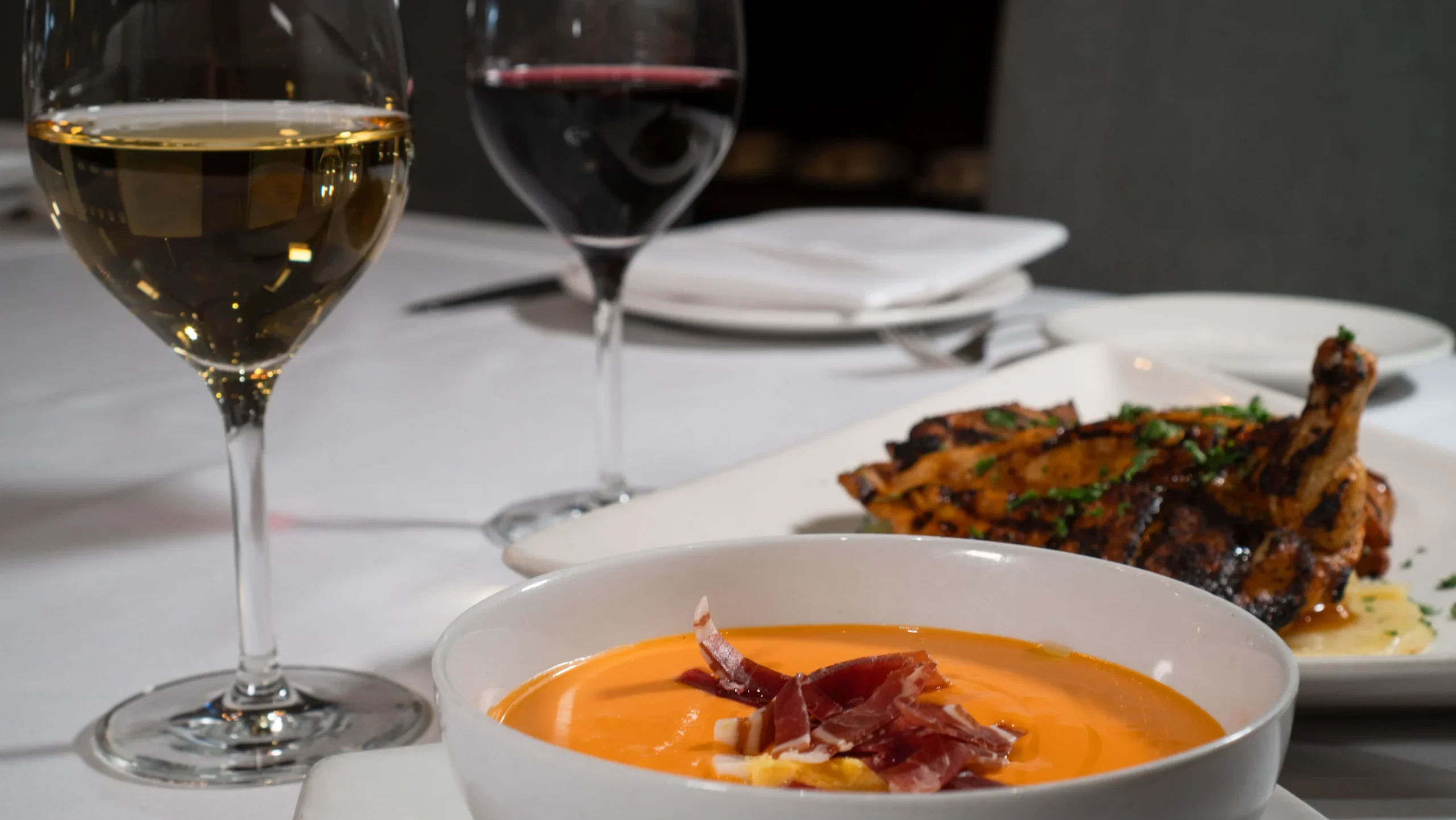 Dining room table with Spanish dishes and wine