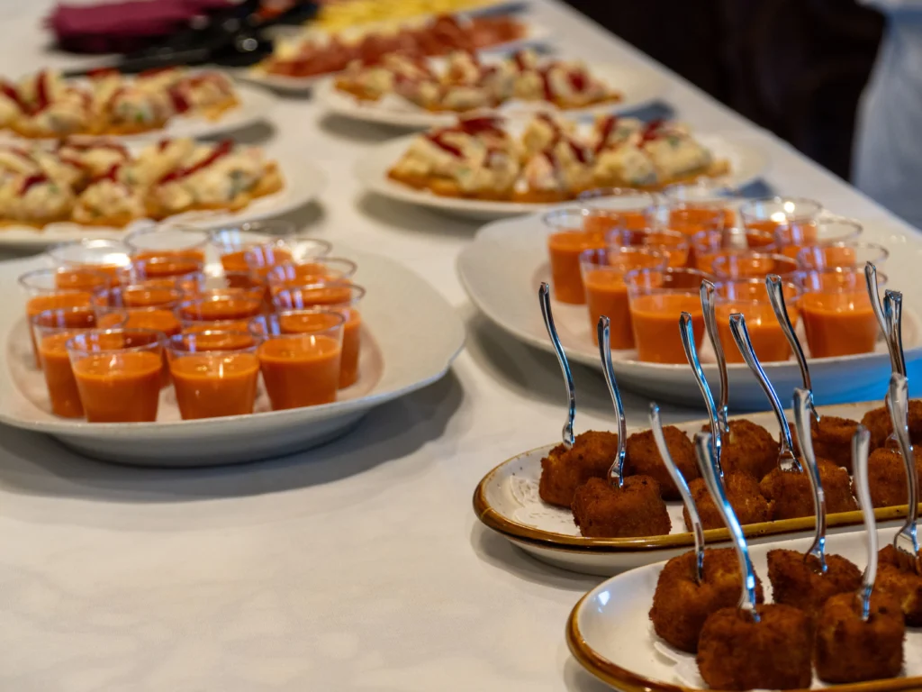 Catering: gazpacho shooters and appetizers on a buffet table