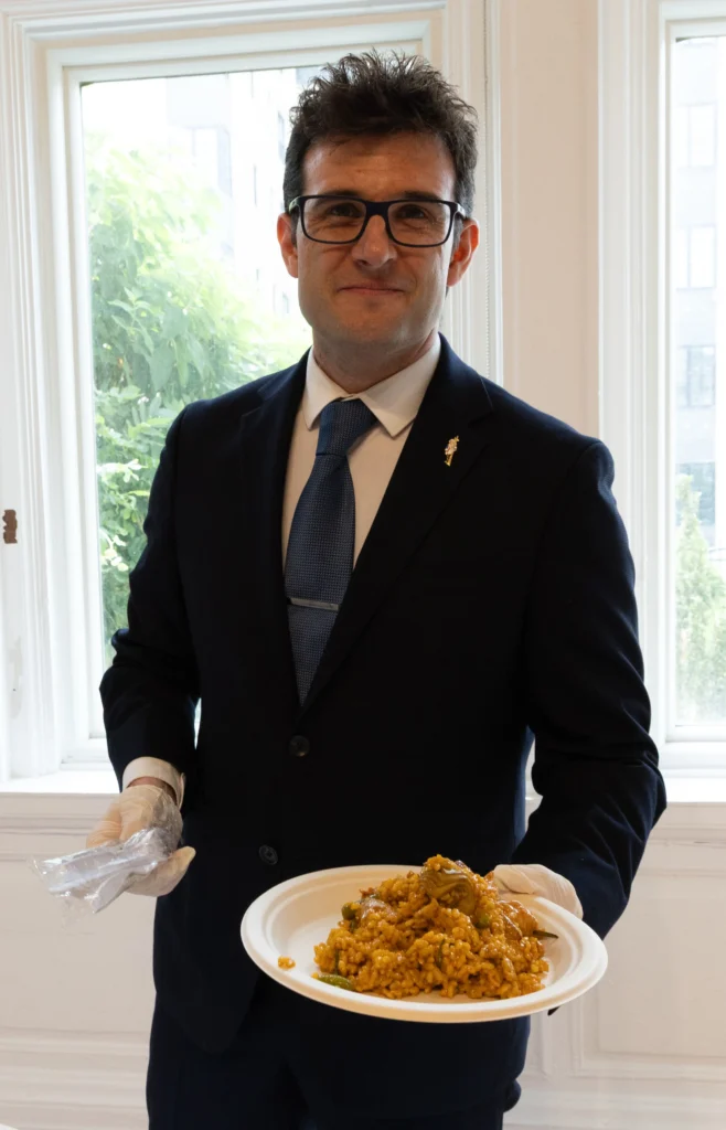 Catering: server presenting a plate of rice at a catered event