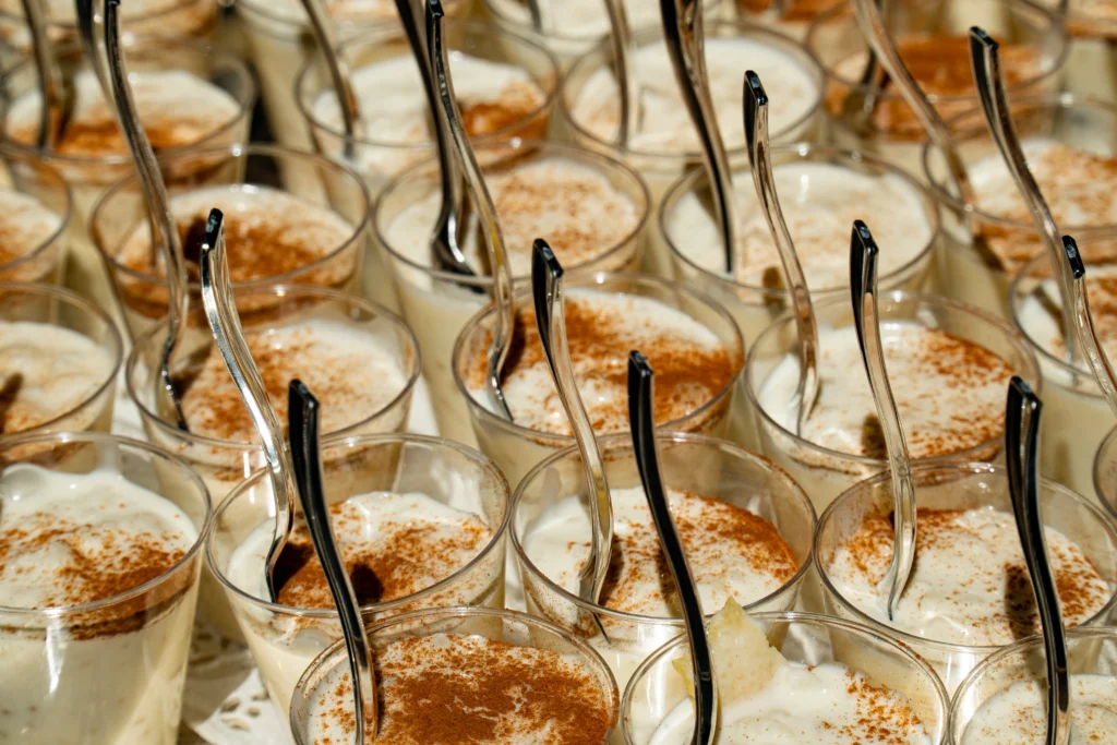 Catering: rice pudding (arroz con leche) served in small glasses with spoons