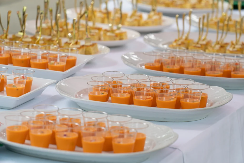 Catering: gazpacho shots and appetizers on a serving table