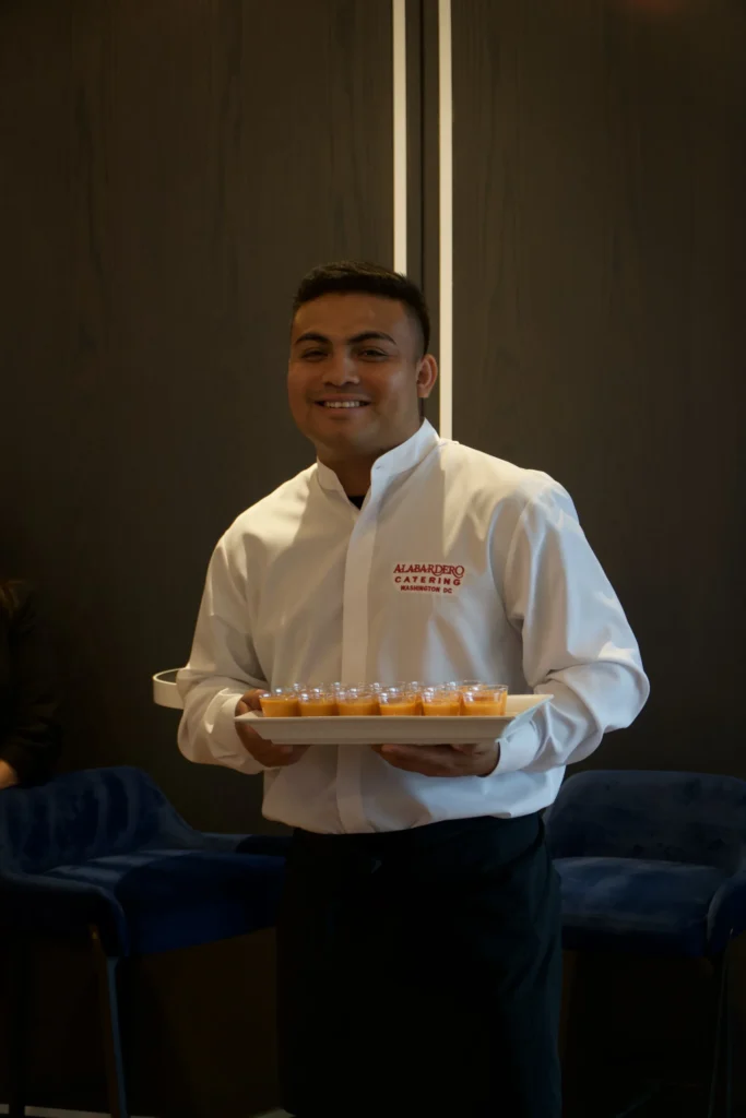 Catering: server carrying a tray of appetizers at a catered event