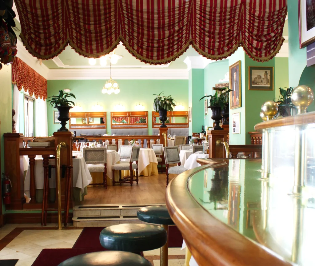 Bar at Taberna del Alabardero: bar and dining room with red curtains